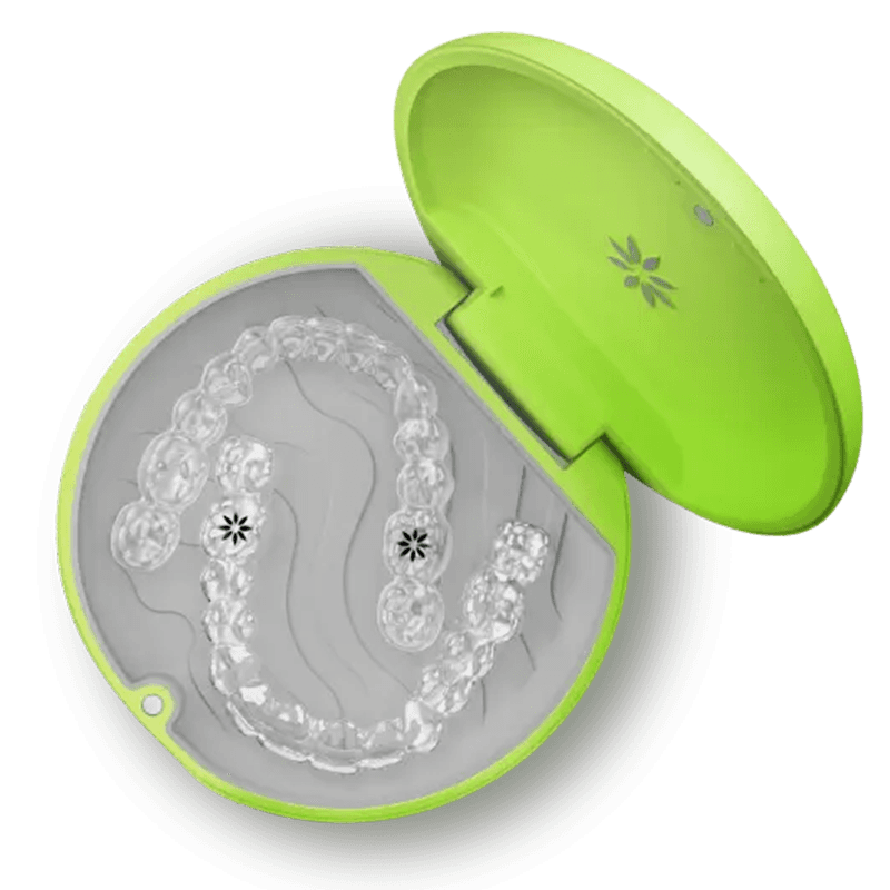 Clear Invisalign aligners resting in an open green carrying case